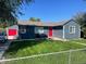 Charming home featuring a well-maintained lawn, eye-catching red door, and detached garage at 1275 S Wolff St, Denver, CO 80219