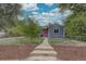 Inviting single story home with gray siding, bright red front door, and fenced front yard at 1275 S Wolff St, Denver, CO 80219