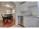 This modern kitchen flows seamlessly into the dining area, perfect for entertaining and Gathering meals at 1275 S Wolff St, Denver, CO 80219