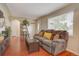 Cozy living room with hardwood floors, comfortable seating, and ample natural light at 1275 S Wolff St, Denver, CO 80219