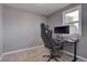 Home office features comfortable chair, desk setup near the window, and neutral wall color at 1275 S Wolff St, Denver, CO 80219