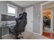 Home office space with ergonomic chair, monitor, and sleek desk setup with a view of another room at 1275 S Wolff St, Denver, CO 80219