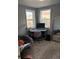 Comfortable home office with corner desk, natural light from two windows, and cozy seating area at 1275 S Wolff St, Denver, CO 80219