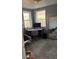 Comfortable home office with corner desk, natural light from two windows, and cozy seating area at 1275 S Wolff St, Denver, CO 80219