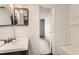 Clean bathroom with vanity, tub and open doorway at 3659 W Union Ave, Denver, CO 80236