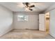 Clean bedroom featuring neutral carpet, ample natural light, and closet space at 3659 W Union Ave, Denver, CO 80236