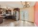 This spacious kitchen features stainless steel appliances, dark cabinetry and an adjacent dining area at 3659 W Union Ave, Denver, CO 80236