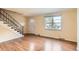 Sunlit living room with hardwood floors, staircase and modern design at 3659 W Union Ave, Denver, CO 80236
