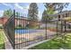 Community pool is surrounded by a secure fence, ensuring a safe and private recreational space at 3659 W Union Ave, Denver, CO 80236