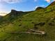 Stunning aerial view of a hillside hiking trail leading to rocky outcroppings and a beautiful vista at 409 Lookout View Dr, Golden, CO 80401