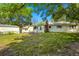 Spacious backyard featuring mature trees, a storage shed, and a partial fence line at 409 Lookout View Dr, Golden, CO 80401
