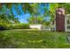 Large, green backyard with mature trees and a detached shed, perfect for outdoor activities at 409 Lookout View Dr, Golden, CO 80401