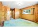 Wood-paneled bedroom with natural light and green carpet, creating a cozy atmosphere at 409 Lookout View Dr, Golden, CO 80401