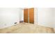 Bedroom with beige carpet, closet, and access door, providing a functional and adaptable living space at 409 Lookout View Dr, Golden, CO 80401