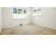 Bright, carpeted bedroom with two windows that provide ample natural light and a view at 409 Lookout View Dr, Golden, CO 80401