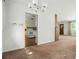 Dining room with carpet, a hanging light, and a view into the kitchen area with white appliances at 409 Lookout View Dr, Golden, CO 80401