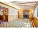 Spacious living room with wood-paneled walls, stone fireplace, and a bright, inviting atmosphere at 409 Lookout View Dr, Golden, CO 80401