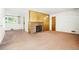 Open living room with pink carpet, brick fireplace with wood paneling, and access to other rooms at 409 Lookout View Dr, Golden, CO 80401