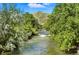 Scenic river view surrounded by lush trees, offering a peaceful natural setting at 409 Lookout View Dr, Golden, CO 80401