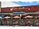 Woody's Wood Fired Pizza with a charming patio and its eye-catching sign, creating a welcoming dining experience at 409 Lookout View Dr, Golden, CO 80401