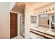A well-maintained bathroom featuring a walk-in shower, large vanity, and ample lighting at 12013 W 56Th Cir, Arvada, CO 80002