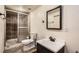 Bathroom featuring a glass shower, toilet, dark vanity, and mirror at 12013 W 56Th Cir, Arvada, CO 80002