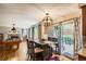 Open-concept dining room area featuring hardwood floors, sliding glass doors to outdoor deck, and pool table at 12013 W 56Th Cir, Arvada, CO 80002