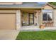 Inviting front porch with stone accents, seating, and charming decor at 12013 W 56Th Cir, Arvada, CO 80002