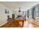 Recreational space featuring a pool table, hardwood floors, and comfortable seating at 12013 W 56Th Cir, Arvada, CO 80002