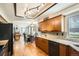 Modern kitchen with wood cabinets, granite counters, and open layout to dining area at 12013 W 56Th Cir, Arvada, CO 80002