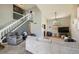 Spacious living room featuring vaulted ceilings, abundant natural light, and comfortable seating at 12013 W 56Th Cir, Arvada, CO 80002