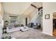 Bright and airy living room featuring high ceilings, neutral decor, and a staircase at 12013 W 56Th Cir, Arvada, CO 80002