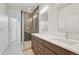 Modern bathroom featuring double vanity, a glass shower, and neutral color palette at 1231 Newton St, Denver, CO 80204