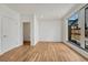 Spacious bedroom featuring hardwood floors and a view of the backyard and access to the bathroom at 1231 Newton St, Denver, CO 80204