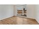Bright bedroom with wood floors and a large window overlooking a fenced backyard at 1231 Newton St, Denver, CO 80204