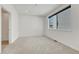 Comfortable bedroom features neutral carpet, recessed lighting, and a large window at 1231 Newton St, Denver, CO 80204