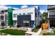 Modern home with well-manicured lawn, blue accents, stone details, and manicured flower beds at 1231 Newton St, Denver, CO 80204
