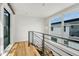 Bright hallway with modern railing and large windows offering natural light at 1231 Newton St, Denver, CO 80204