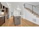 Well-lit kitchen with a modern design and stainless steel appliances, including a view of the staircase at 1231 Newton St, Denver, CO 80204