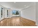 Bright living room featuring hardwood floors, modern recessed lighting, and expansive windows at 1231 Newton St, Denver, CO 80204