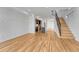 Spacious living area showcasing hardwood floors, staircase, and modern kitchen with island at 1231 Newton St, Denver, CO 80204