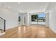 Bright living room featuring hardwood floors, large windows, and neutral paint, creating a warm ambiance at 1231 Newton St, Denver, CO 80204