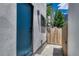Side yard featuring a metal gate, painted walls, and privacy fencing at 1231 Newton St, Denver, CO 80204