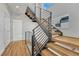 Modern staircase with wood steps, a metal railing, and plenty of natural light at 1231 Newton St, Denver, CO 80204