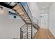 Modern staircase featuring wood treads, open risers, and black metal railings at 1231 Newton St, Denver, CO 80204