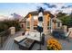 Large outdoor deck with wicker lounge furniture, umbrella and views of surrounding trees at 724 Evening Star Dr, Castle Rock, CO 80108