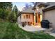 Backyard patio with outdoor seating, barbecue, manicured lawn and lush landscaping at 724 Evening Star Dr, Castle Rock, CO 80108