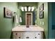 Bright bathroom featuring a single sink vanity with white cabinets and colorful wall decor at 724 Evening Star Dr, Castle Rock, CO 80108