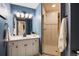 Charming bathroom with a stand up shower, white cabinetry, and a white countertop at 724 Evening Star Dr, Castle Rock, CO 80108