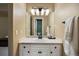 Well-lit bathroom featuring a white vanity with drawers and mirror, exuding cleanliness and functionality at 724 Evening Star Dr, Castle Rock, CO 80108